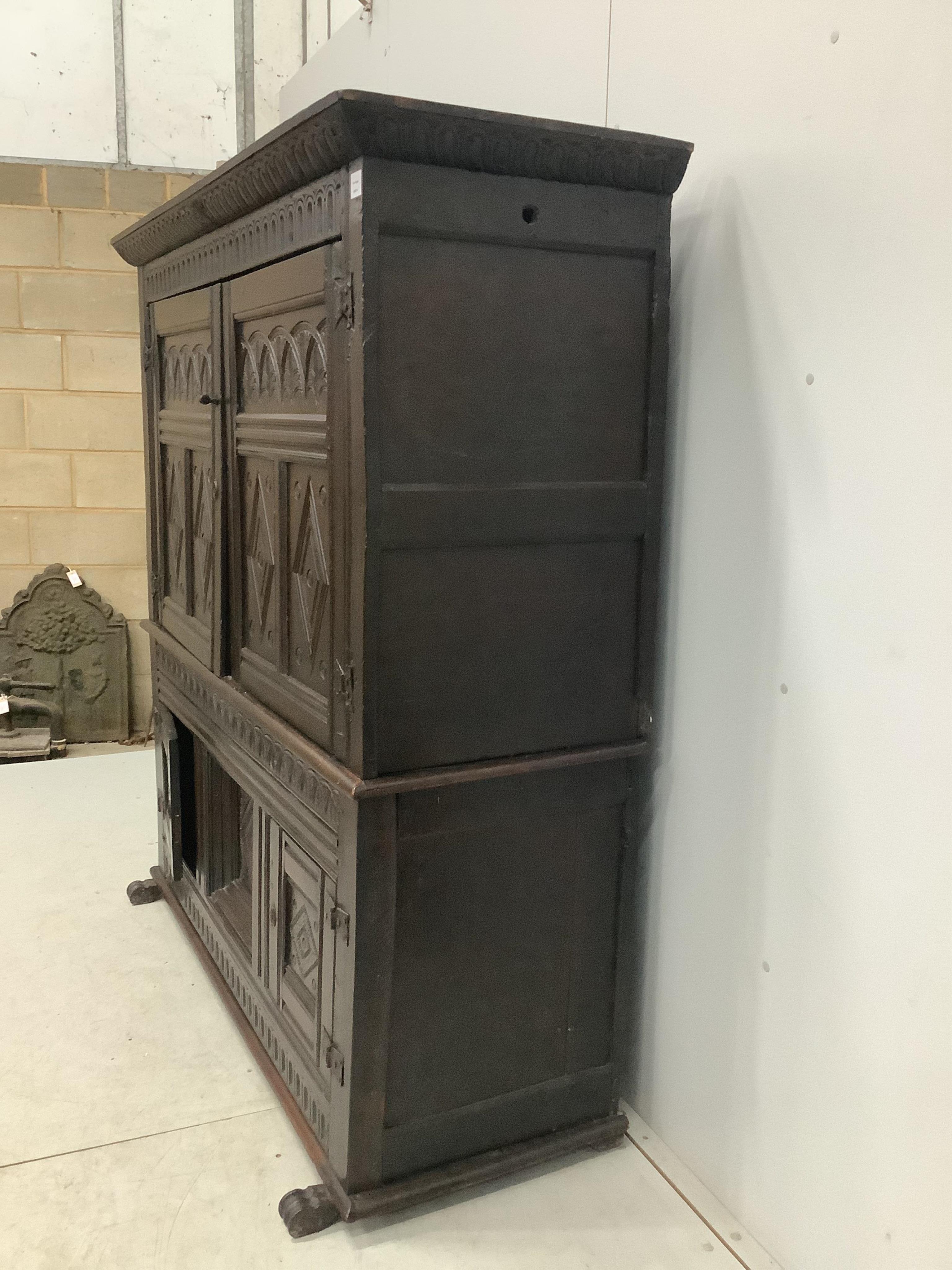 A late 17th century Continental carved oak two section cupboard, width 166cm, depth 57cm, height 167cm. Condition - fair